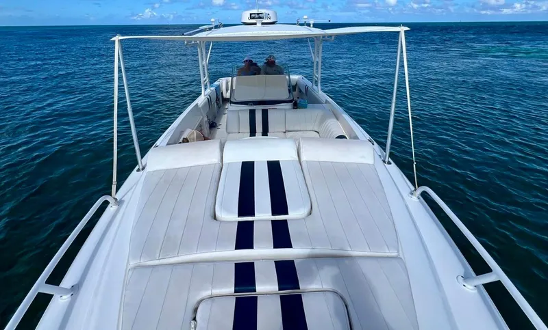 Galore Yacht Photos Pics 2006 Intrepid 323 Cuddy boat on open water, featuring spacious deck and seating.