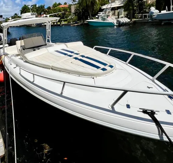 Galore Yacht Photos Pics 2006 Intrepid 323 Cuddy boat docked on a sunny waterfront.