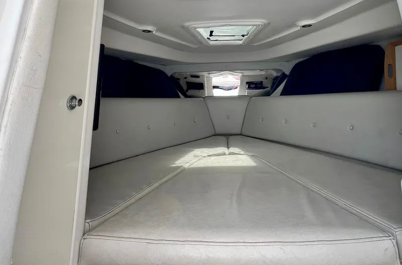 Galore Yacht Photos Pics Interior of 2006 Intrepid 323 Cuddy cabin with white cushioned seating.