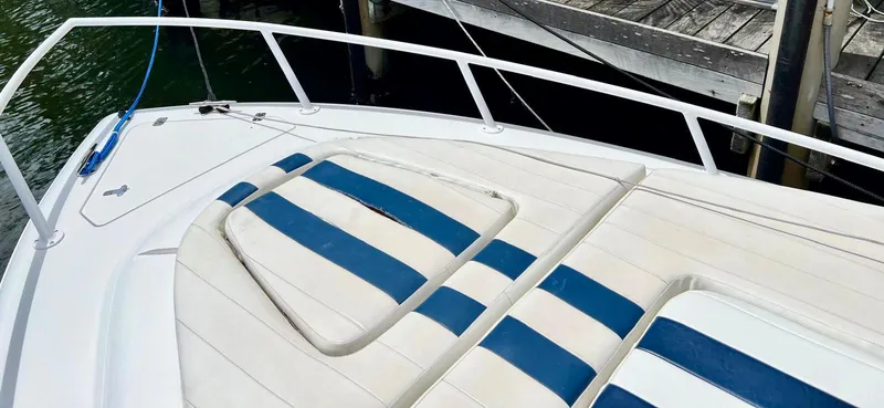 Galore Yacht Photos Pics 2006 Intrepid 323 Cuddy boat with striped seating near dock.