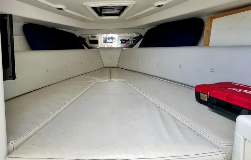 Galore Yacht Photos Pics 2006 Intrepid 323 Cuddy cabin interior with white cushions and storage space.