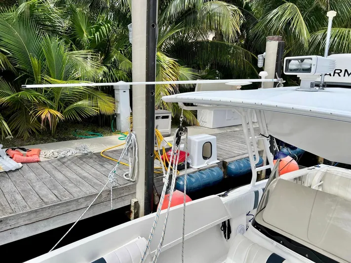 Galore Yacht Photos Pics 2006 Intrepid 323 Cuddy boat docked near tropical foliage.