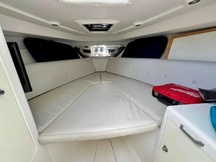 Galore Yacht Photos Pics Interior of 2006 Intrepid 323 Cuddy boat with cushioned seating and storage.