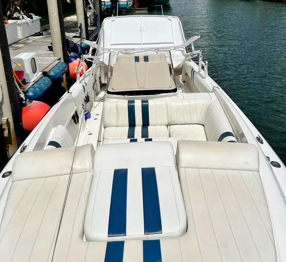 Galore Yacht Photos Pics 2006 Intrepid 323 Cuddy boat with white and blue seating, docked by the water.