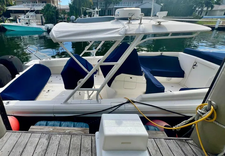 Galore Yacht Photos Pics 2006 Intrepid 323 Cuddy boat docked with blue seating and canopy.