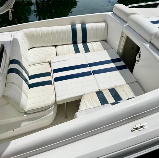 Galore Yacht Photos Pics 2006 Intrepid 323 Cuddy boat interior with white and blue striped seating.