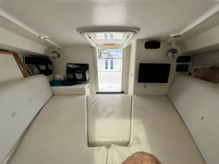 Galore Yacht Photos Pics Interior of 2006 Intrepid 323 Cuddy, featuring white seating and modern amenities.