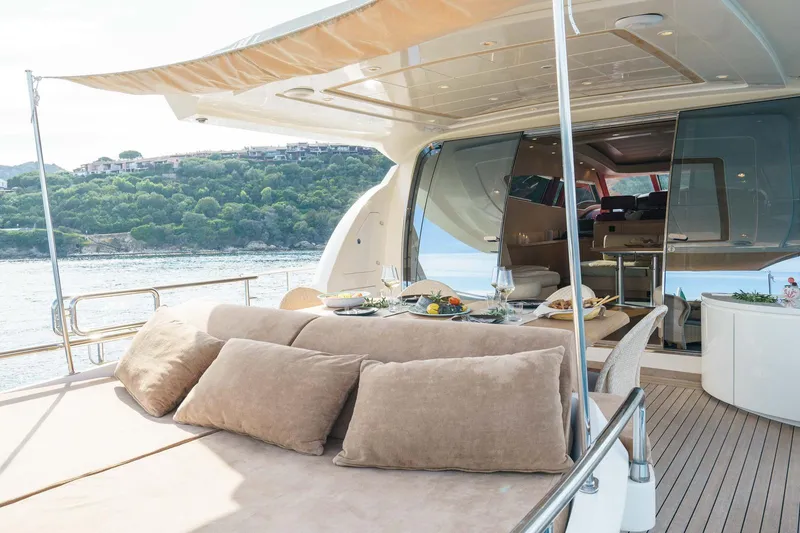 Allie Yacht Photos Pics Luxurious 2008 Alalunga Open 85 Sport X yacht with elegant outdoor dining area and scenic views.