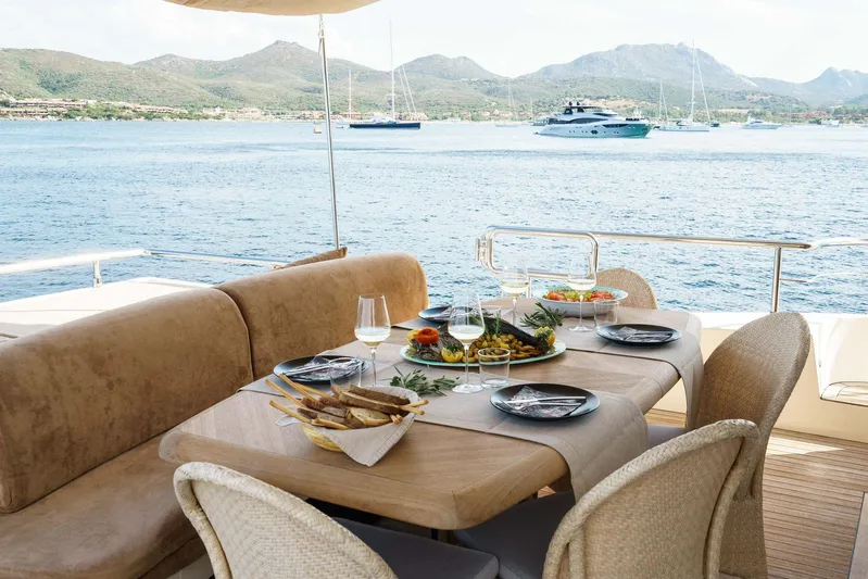 Allie Yacht Photos Pics Luxurious dining setup on 2008 Alalunga Open 85 Sport X yacht with scenic ocean view.