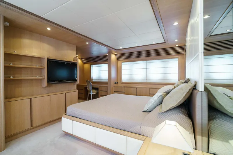 Allie Yacht Photos Pics Luxurious bedroom interior of 2008 Alalunga Open 85 Sport X yacht, featuring modern design and wood accents.