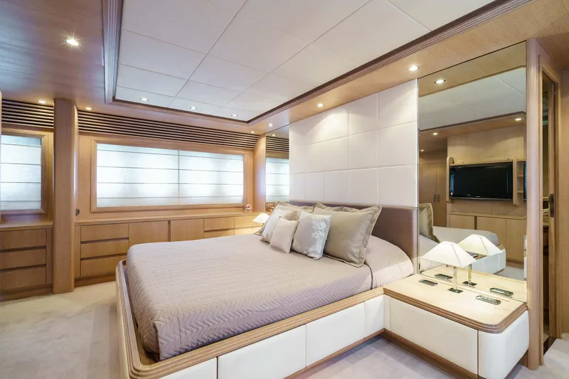 Allie Yacht Photos Pics Luxurious bedroom interior of 2008 Alalunga Open 85 Sport X yacht, featuring elegant wood finishes.