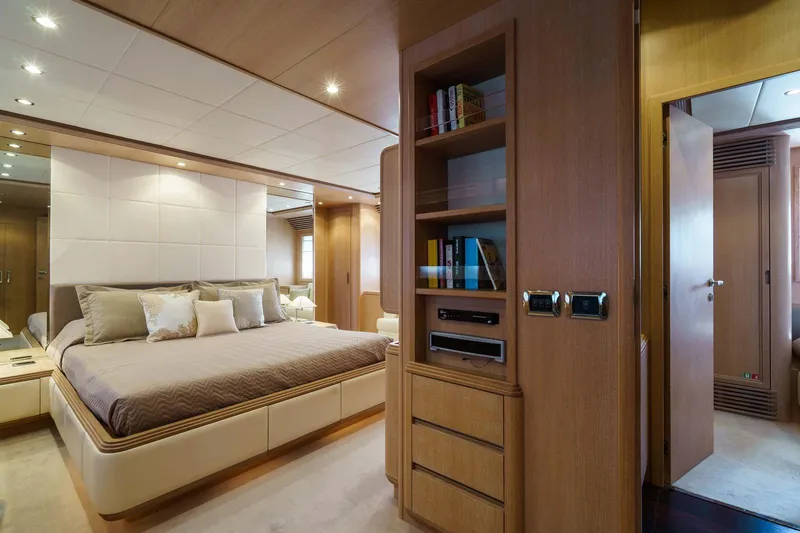 Allie Yacht Photos Pics Luxurious bedroom interior of 2008 Alalunga Open 85 Sport X yacht, featuring elegant wood finishes.