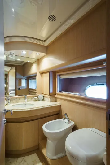 Allie Yacht Photos Pics Luxurious bathroom in 2008 Alalunga Open 85 Sport X yacht with wood accents and marble countertop.