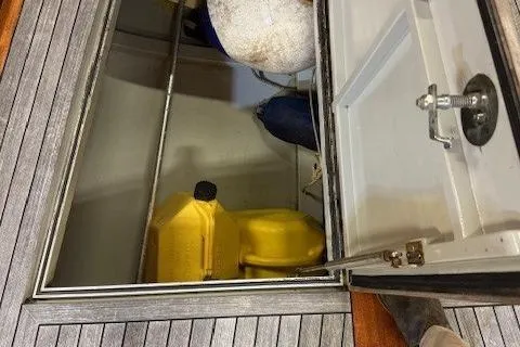 Bamboozle Yacht Photos Pics Open storage compartment on 2010 Spirit Yachts R46 with yellow fuel containers.