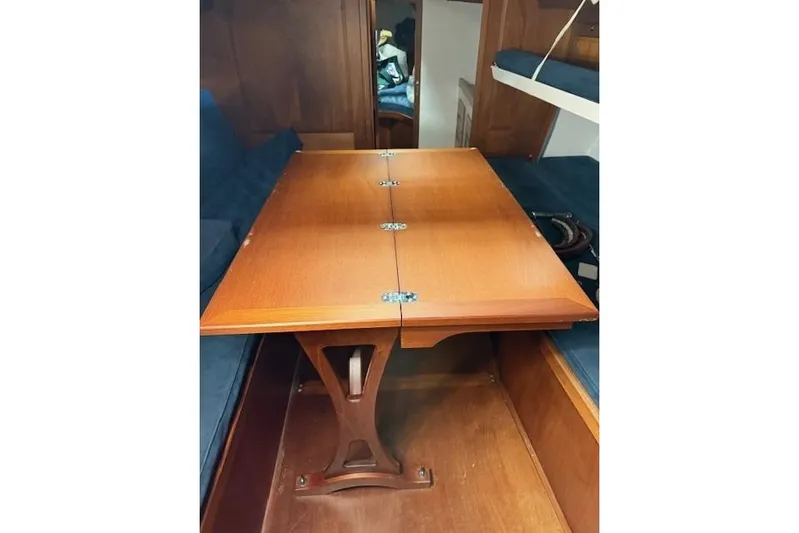 Bamboozle Yacht Photos Pics Interior of 2010 Spirit Yachts R46, featuring a wooden foldable table and blue seating.