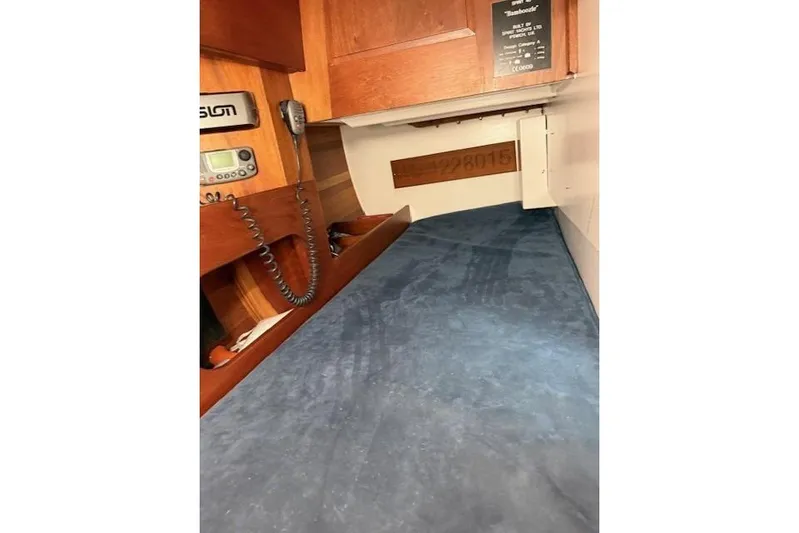 Bamboozle Yacht Photos Pics Interior cabin of 2010 Spirit Yachts R46, featuring wooden paneling and communication equipment.