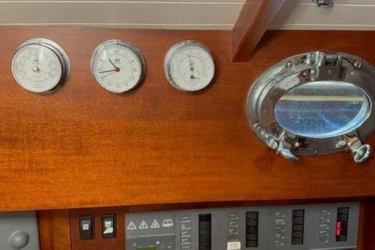 Bamboozle Yacht Photos Pics Interior of 2010 Spirit Yachts R46 with gauges and porthole on wooden panel.