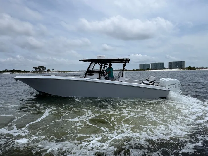  Yacht Photos Pics 2022 Fountain 38TE boat cruising on open water under cloudy skies.