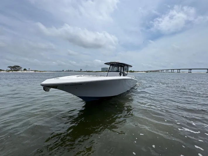  Yacht Photos Pics 2022 Fountain 38TE boat on calm water under cloudy sky.