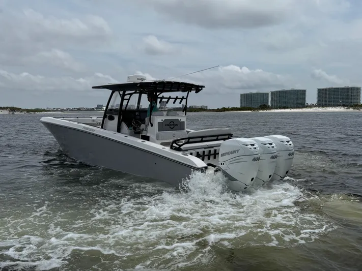  Yacht Photos Pics 2022 Fountain 38TE boat with triple Mercury engines cruising on water, cityscape in background.