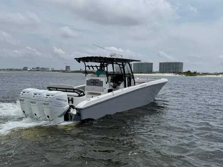  Yacht Photos Pics 2022 Fountain 38TE boat cruising on water with triple 400 horsepower engines.