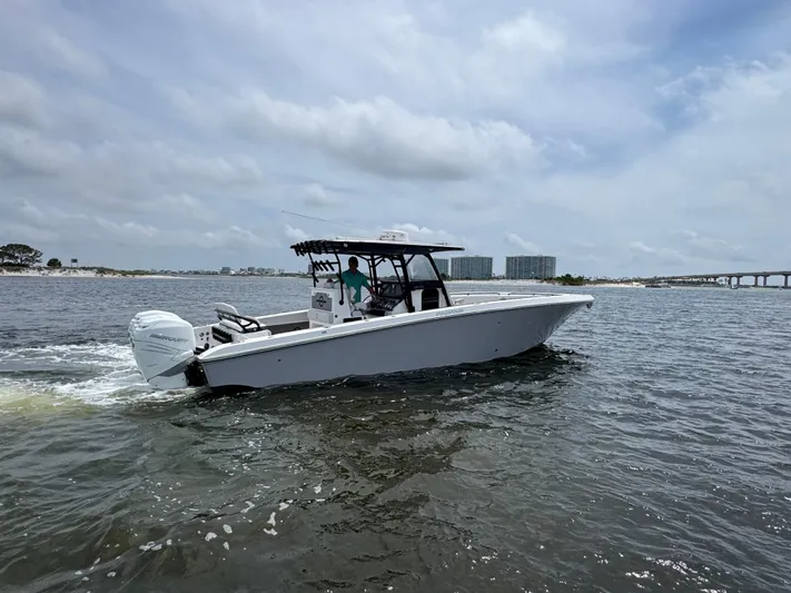  Yacht Photos Pics 2022 Fountain 38TE boat cruising on open water under a cloudy sky.