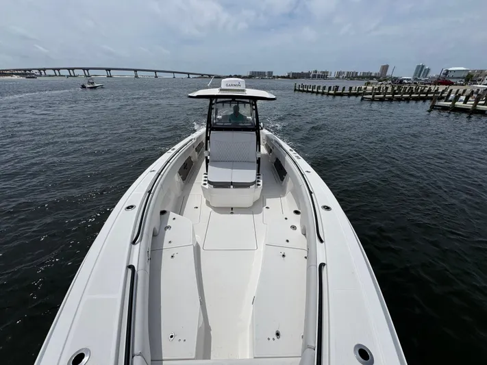  Yacht Photos Pics 2022 Fountain 38TE boat on water, bridge and cityscape in background.