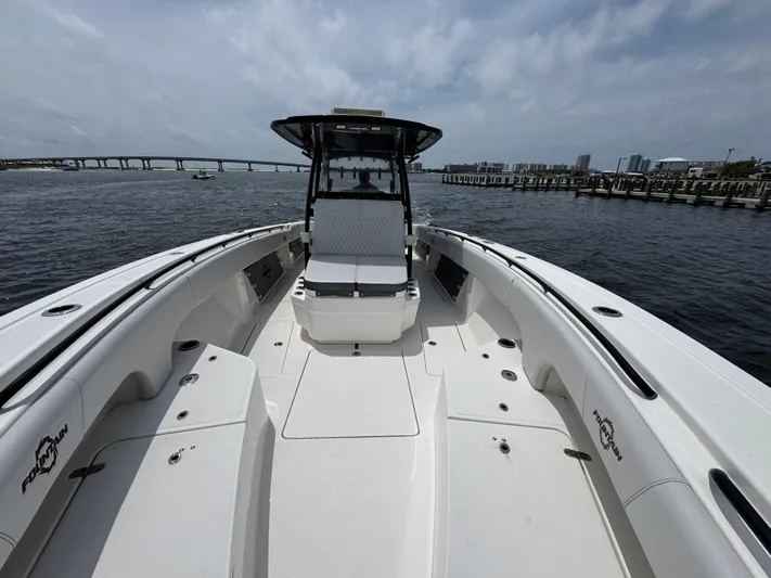  Yacht Photos Pics 2022 Fountain 38TE boat on water with bridge and city skyline in background.