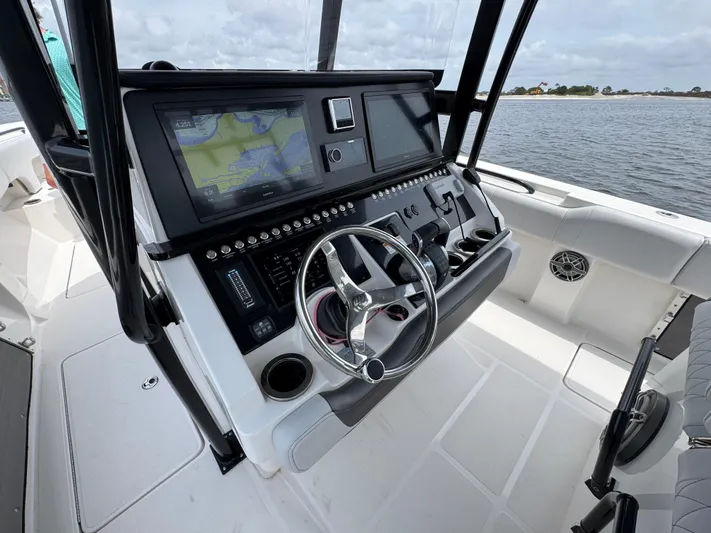  Yacht Photos Pics 2022 Fountain 38TE boat dashboard with navigation system and steering wheel.