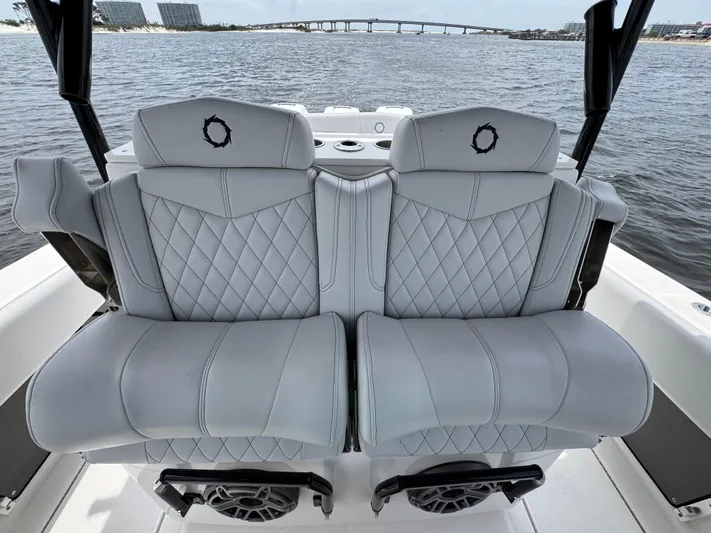  Yacht Photos Pics Luxury seating on 2022 Fountain 38TE boat with quilted design, overlooking water and bridge.