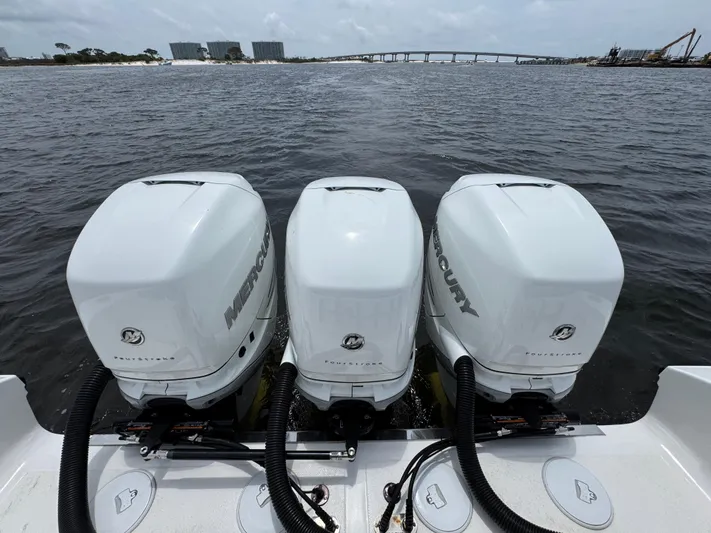  Yacht Photos Pics Triple Mercury outboard engines on a 2022 Fountain 38TE boat, cruising on open water.