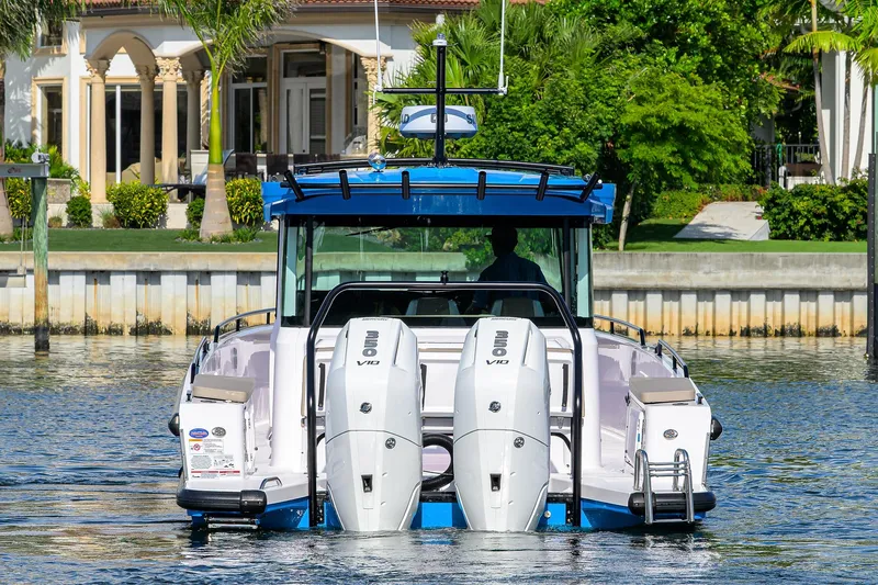  Yacht Photos Pics 2024 Axopar XC Cross Cabin Brabus boat with dual engines on a calm waterway.