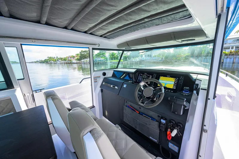  Yacht Photos Pics Interior of 2024 Axopar XC Cross Cabin Brabus, featuring modern dashboard and waterfront view.