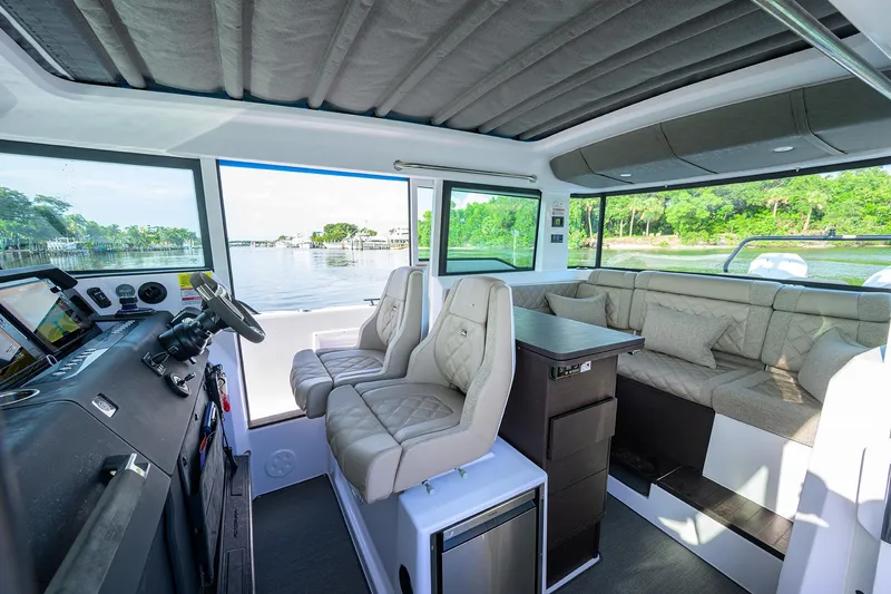  Yacht Photos Pics 2024 Axopar XC Cross Cabin Brabus interior with plush seating and modern dashboard.