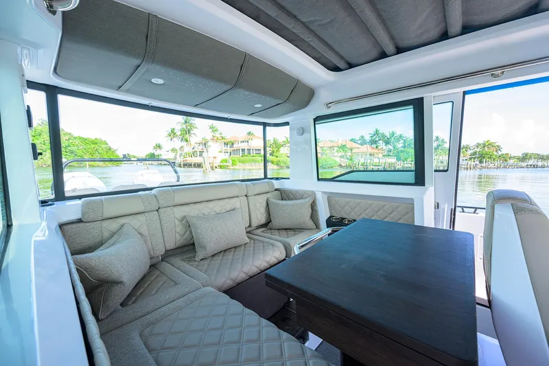 Yacht Photos Pics 2024 Axopar XC Cross Cabin Brabus interior with luxurious seating and scenic water views.