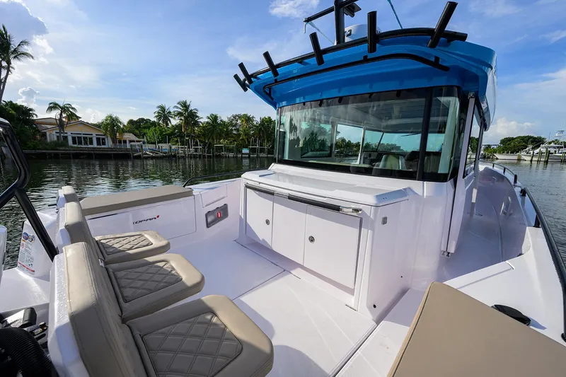  Yacht Photos Pics 2024 Axopar XC Cross Cabin Brabus boat with spacious seating and sleek design on a sunny day.