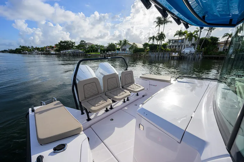  Yacht Photos Pics 2024 Axopar XC Cross Cabin Brabus boat on calm water, featuring sleek seating and modern design.