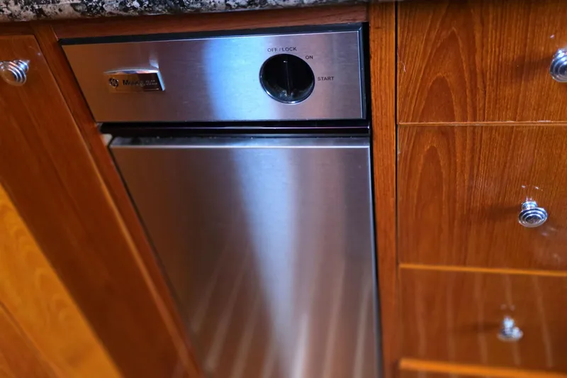 Aspen Afloat Yacht Photos Pics 1974 Chris-Craft Roamer kitchen with stainless steel appliance and wooden cabinetry.