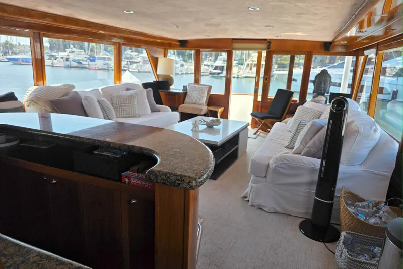 Aspen Afloat Yacht Photos Pics Luxurious 1974 Chris-Craft Roamer yacht interior with elegant seating and marina view.