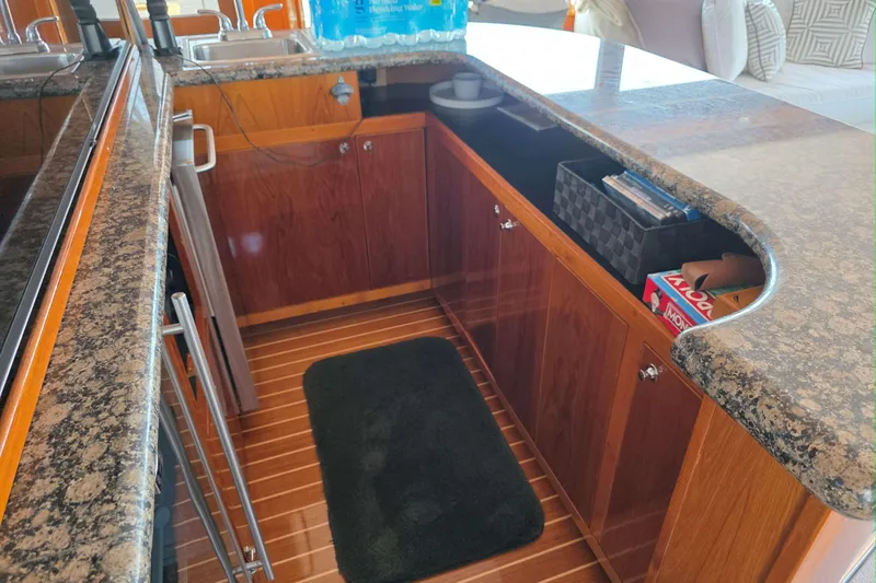 Aspen Afloat Yacht Photos Pics 1974 Chris-Craft Roamer yacht interior with granite countertops and wooden cabinetry.