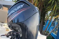 Mercury outboard motor on 2016 Quicksilver Activ 605 Open boat, near tropical plants.