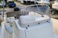 2016 Quicksilver Activ 605 Open boat with windshield and seating, docked in a marina.
