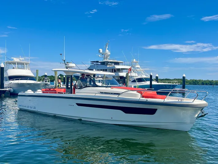 Fla#98 Yacht Photos Pics 2022 Nimbus T11 #98 TRADE! boat docked in a marina under a clear blue sky.