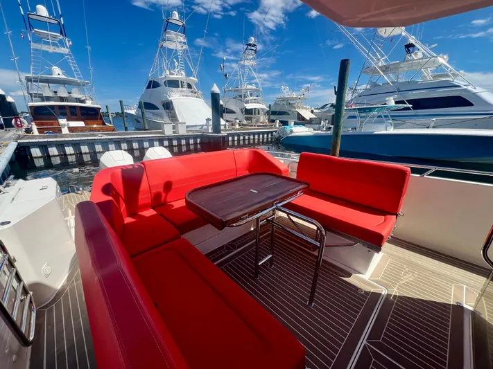 Fla#98 Yacht Photos Pics Red seating area on 2022 Nimbus T11 #98 TRADE! yacht, docked with other boats.