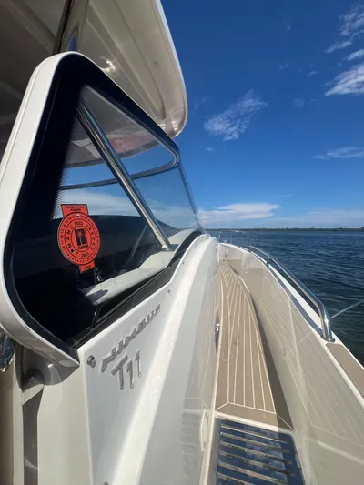 Fla#98 Yacht Photos Pics 2022 Nimbus T11 boat on water, showcasing sleek design and clear blue sky.