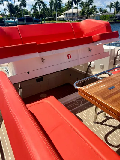 Fla#98 Yacht Photos Pics Red seating and wooden table on 2022 Nimbus T11 #98 TRADE! boat deck.