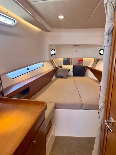 Fla#98 Yacht Photos Pics Cozy cabin interior of 2022 Nimbus T11 #98 TRADE! with comfortable bedding and wooden accents.