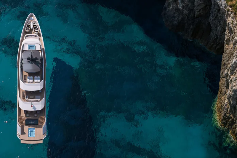Sleek 52 Yacht Photos Pics Luxurious Tureddi Sleek 52 yacht cruising near rocky coastline, 2028 model.