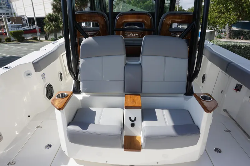 Bwce0497i324 Yacht Photos Pics 2024 Boston Whaler 360 Outrage boat seating area with cup holders and modern design.