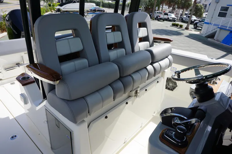 Bwce0497i324 Yacht Photos Pics 2024 Boston Whaler 360 Outrage boat interior with luxurious seating and modern helm.